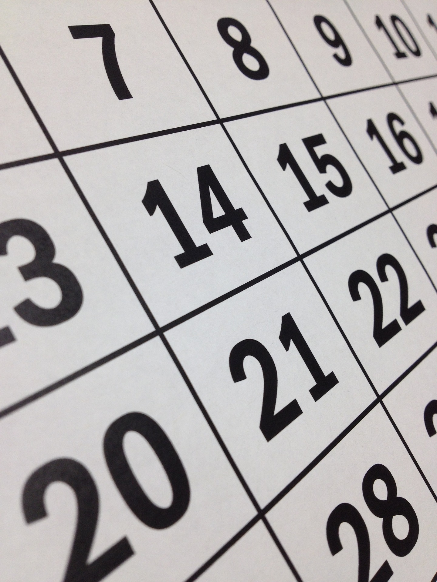 A close-up view of a calendar page showing dates in bold black numbers, highlighting the 7th, 14th, and 21st days.